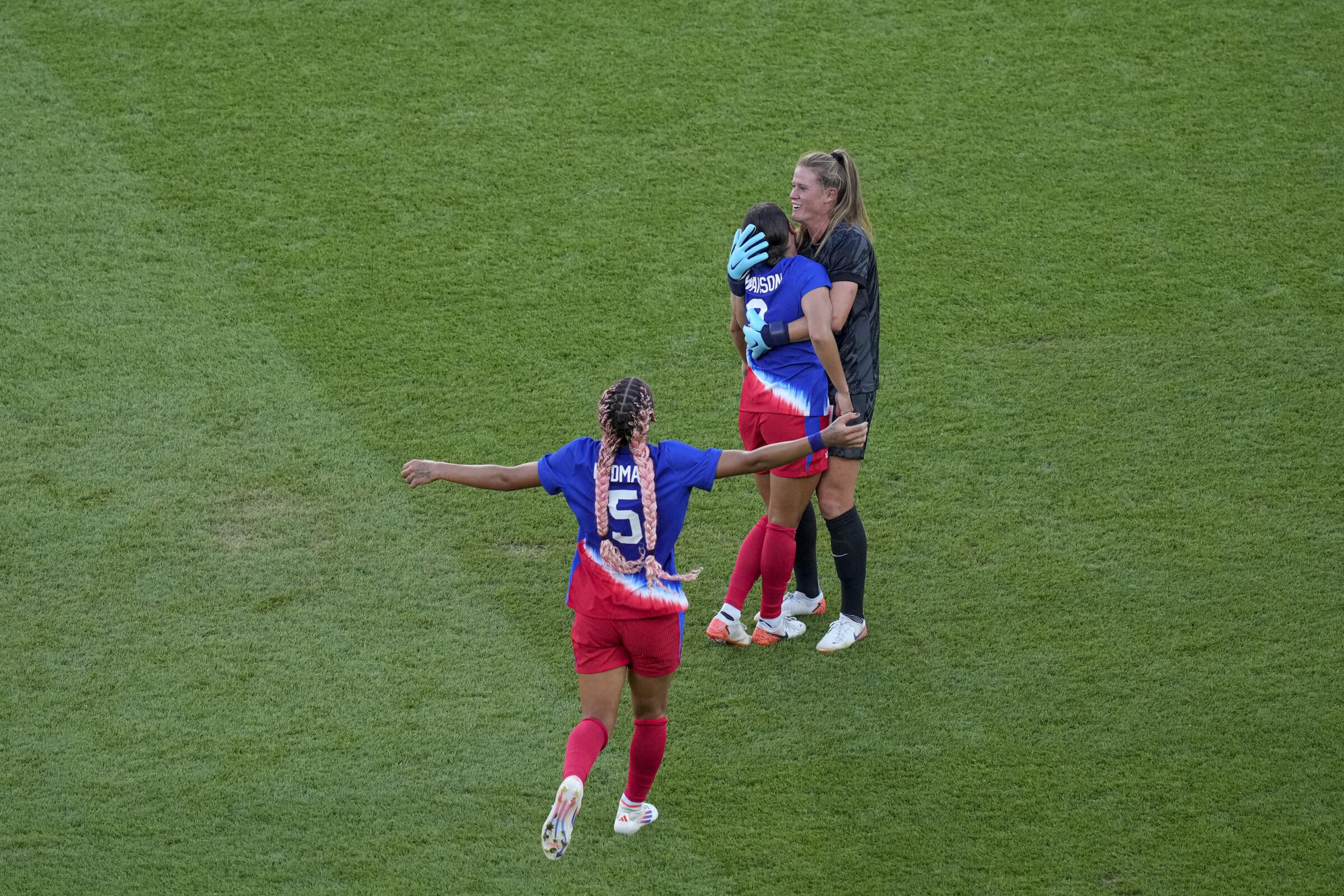 U.S. goalkeeper Alyssa Naeher hugs Mallory Swanson as they celebrate beating Brazil to win the gold medal