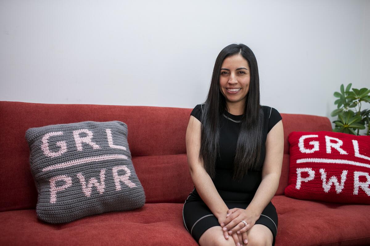 Daisy Esparza sits with a "Grl Pwr" pillow on Monday, Oct. 24, 2022 in Santa Ana.