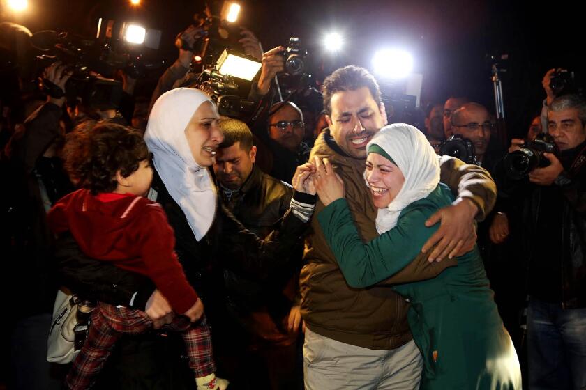 A man comforts the wife of captive Jordanian pilot Lt. Moaz Kasasbeh during a protest in Amman, Jordan, on Wednesday.