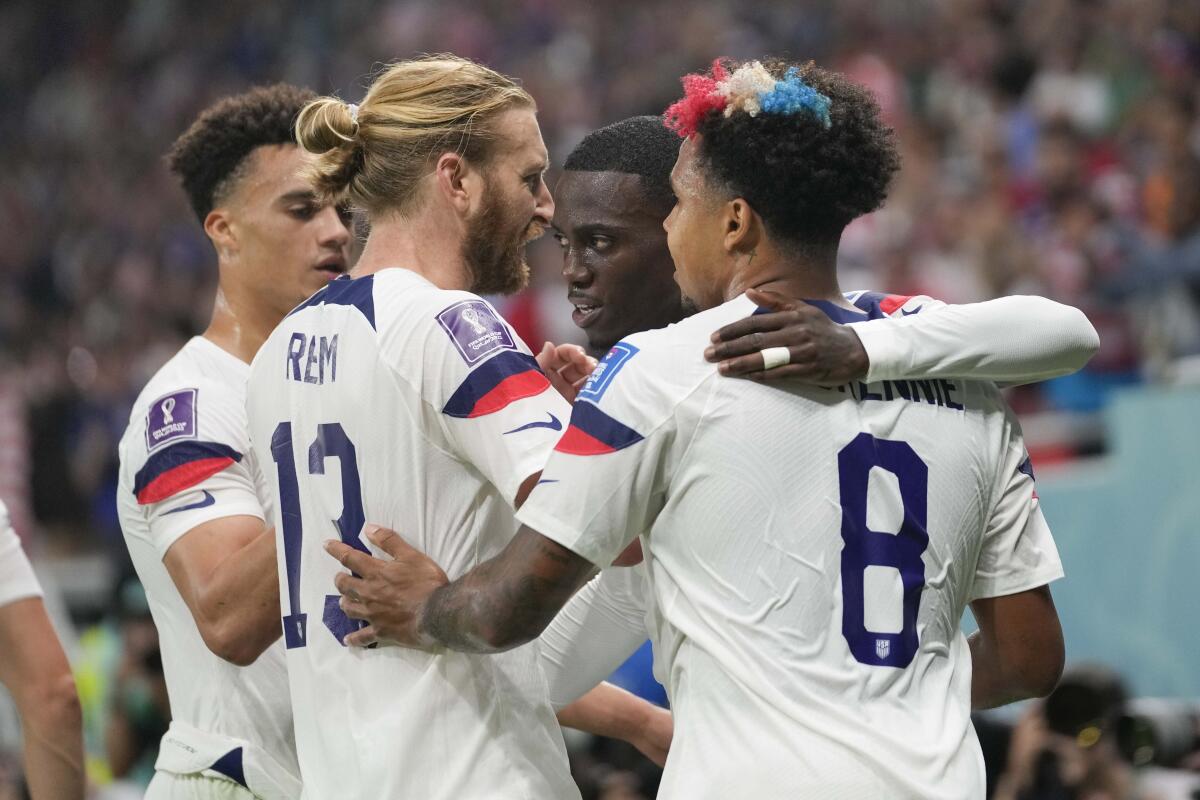 Tim Weah, second right, celebrates with teammates after scoring for the U.S. in the first half.