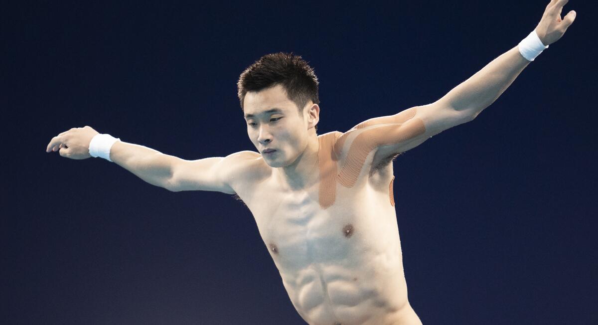 China's Yuan Cao dives with tape on his shoulder at the Tokyo Olympics.