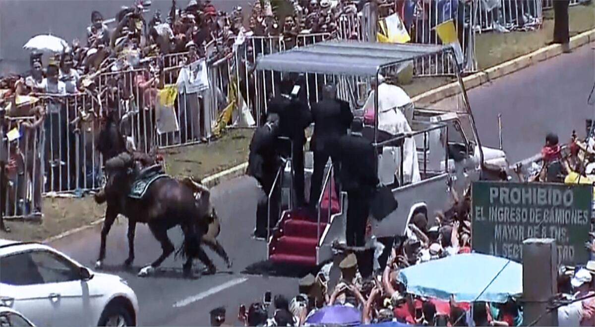 A still image from video shows a mounted police officer being thrown from her horse after it was frightened by crowds cheering Pope Francis in Iquique, Chile.
