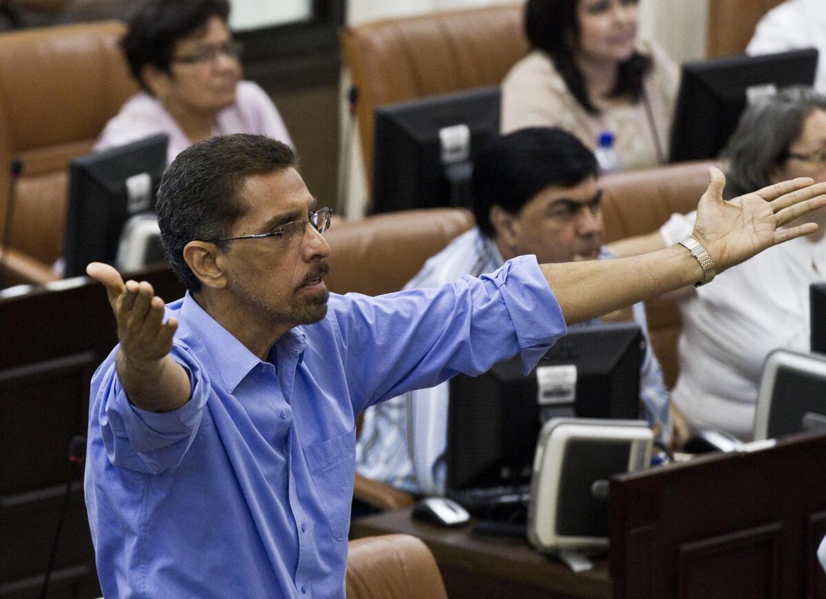 FILE - Opposition legislator Victor Hugo Tinoco, of the Sandinista Renewal Movement (MRS) gestures before the National Assembly votes to amend the Nicaraguan Constitution to include eliminating presidential term limits in Managua, Nicaragua, Jan. 28, 2014. Nicaraguan judges on Monday, Feb. 21, 2022, have sentenced Tinoco to 13 years in prison for “conspiracy to undermine national integrity.” (AP Photo/Esteban Felix, File)