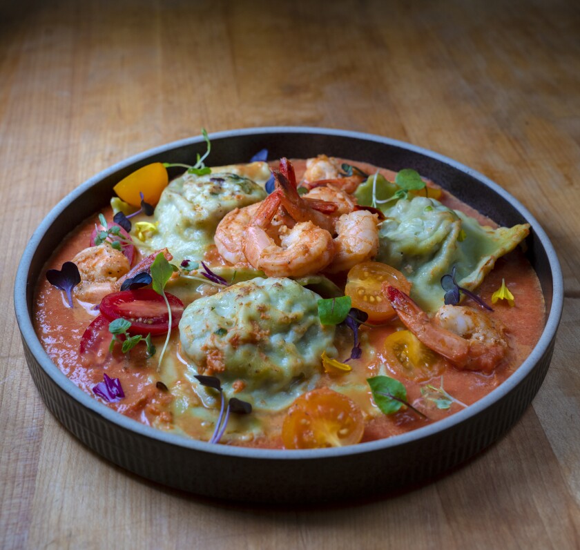 Spinach ravioli, filled with fennel ground beef, pan-seared shrimp marinated with fresh lemon zest.
