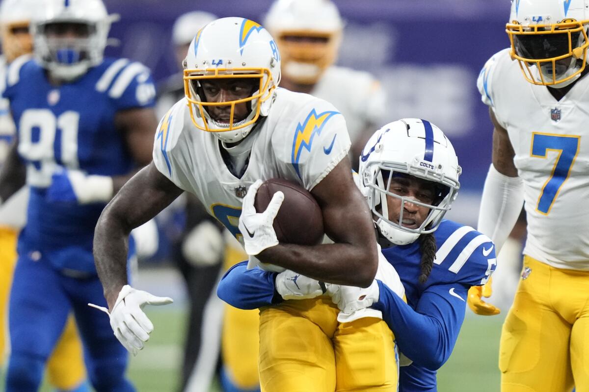 Chargers' Mike Williams is tackled by Indianapolis Colts' Stephon Gilmore.