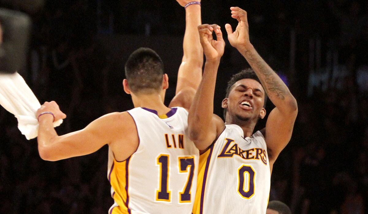 Lakers point guard Jeremy Lin (17) and forward Nick Young (0) celebrate after defeating the Pacers, 88-87.