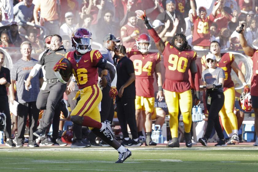 USC receiver Tahj Washington looks back after pulling in a 76-yard touchdown pass 