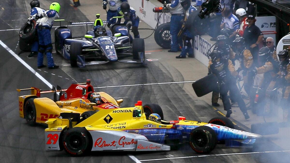 Ryan Hunter-Reay, driver of the No. 28 DHL Andretti Autosport Honda, and teammate Townsend Bell collide on pit road during the Indy 500 on Sunday.