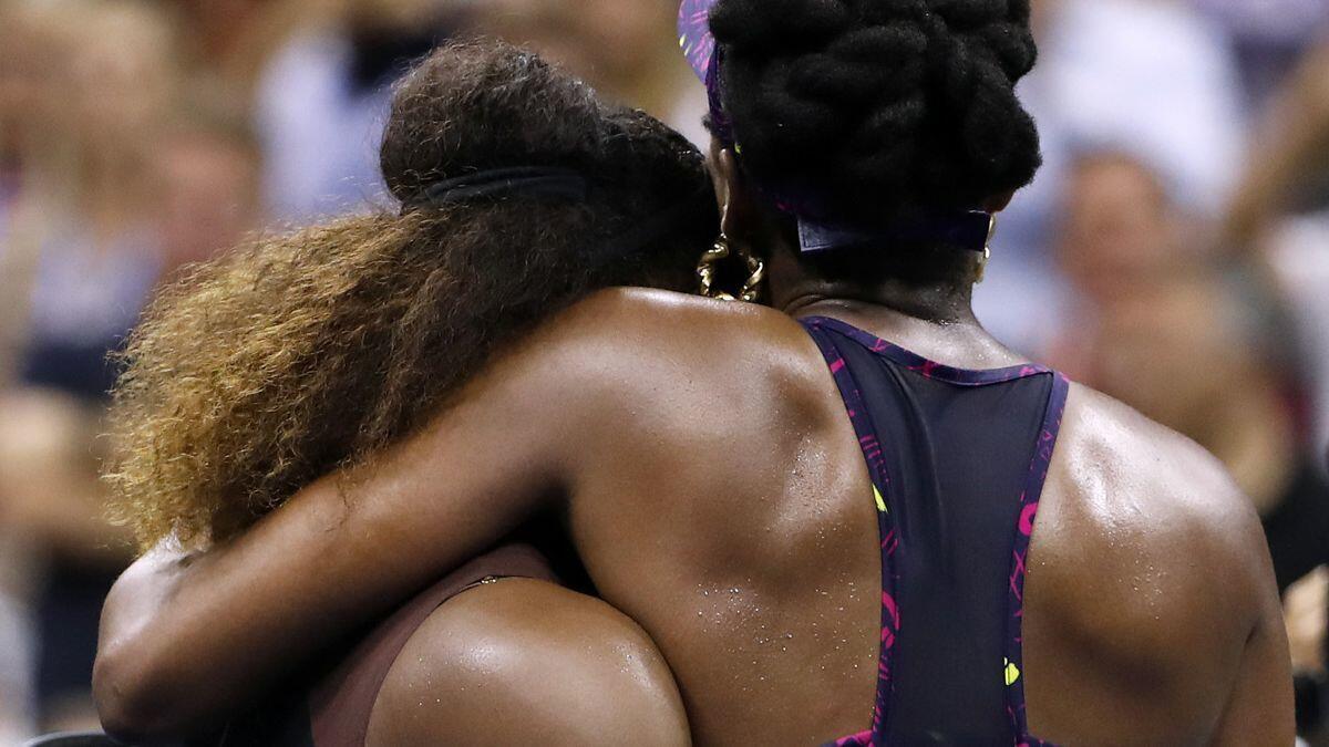 Serena Williams, left, embraces her sister Venus Williams after their third-round match at the U.S. Open on Friday.