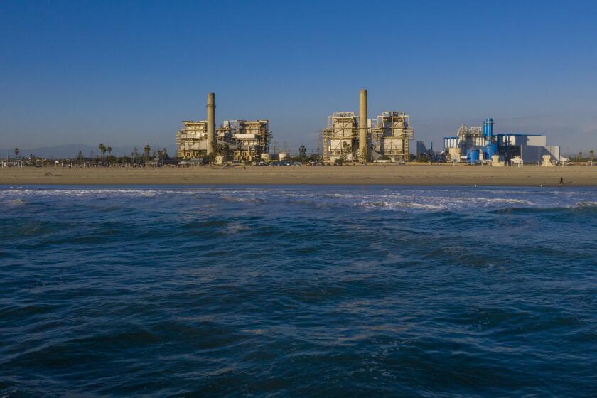 HUNTINGTON BEACH, CA - February 17: A view of the older AES Huntington Beach Power Station at left, and new one at right, and is the proposed site of the Poseidon Desalination Plant, which would draw ocean water through an existing intake pipe at Wednesday, Feb. 17, 2021 in Huntington Beach, CA. (Allen J. Schaben / Los Angeles Times)