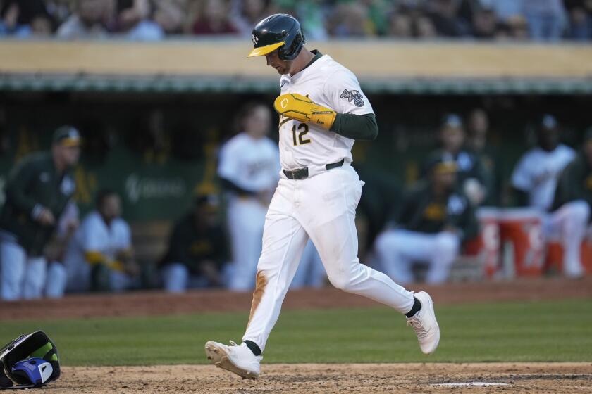 Oakland Athletics' Max Schuemann scores on a wild pitch by Toronto Blue Jays' Chris Bassitt during the sixth inning of a baseball game Friday, June 7, 2024, in Oakland, Calif. (AP Photo/Godofredo A. Vásquez)