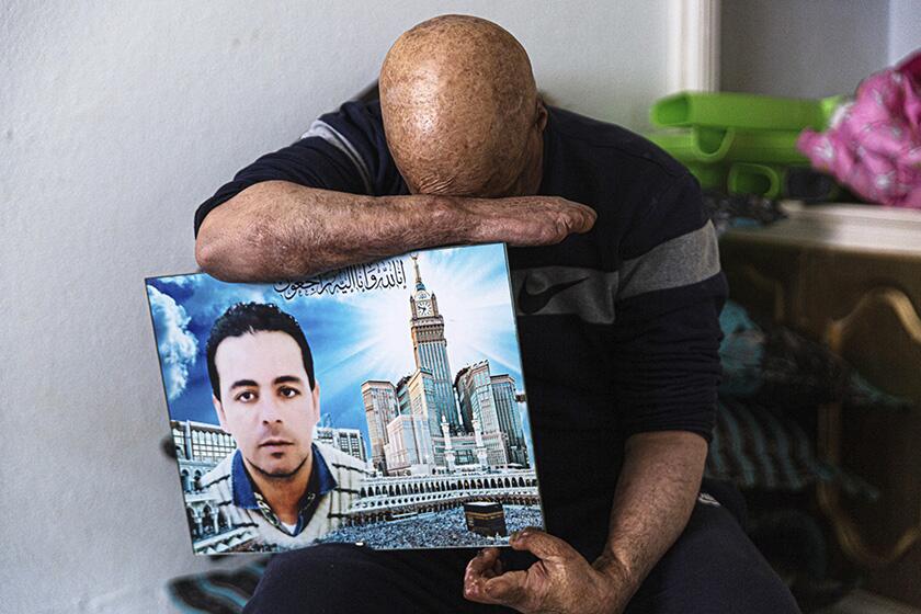Hosni Kalaia, 49, with a photo of his younger brother, Sabre, who died after setting himself ablaze in 2015. Kalaia survived setting himself on fire in 2011.