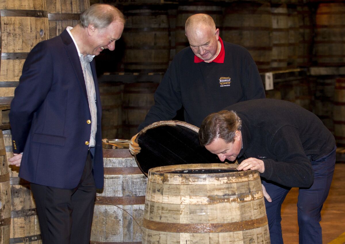 British Prime Minister David Cameron smells a whiskey barrel during a visit to the Bushmills distillery in Northern Ireland on Feb. 27.