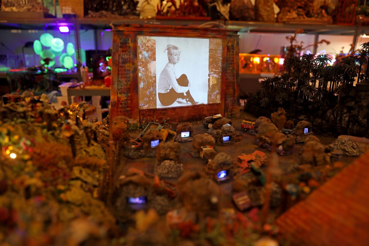 A diorama of cars at a drive-in movie theater