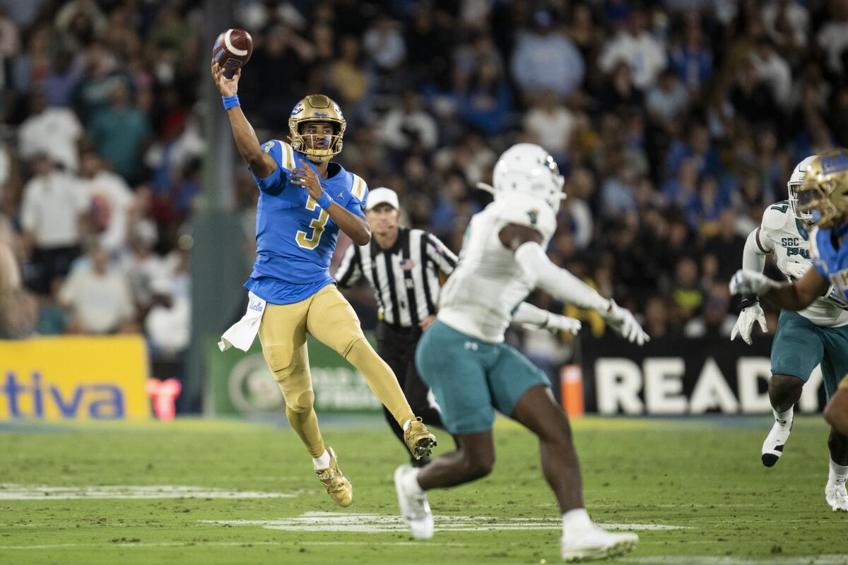 UCLA quarterback Dante Moore throws a pass against Coastal Carolina 