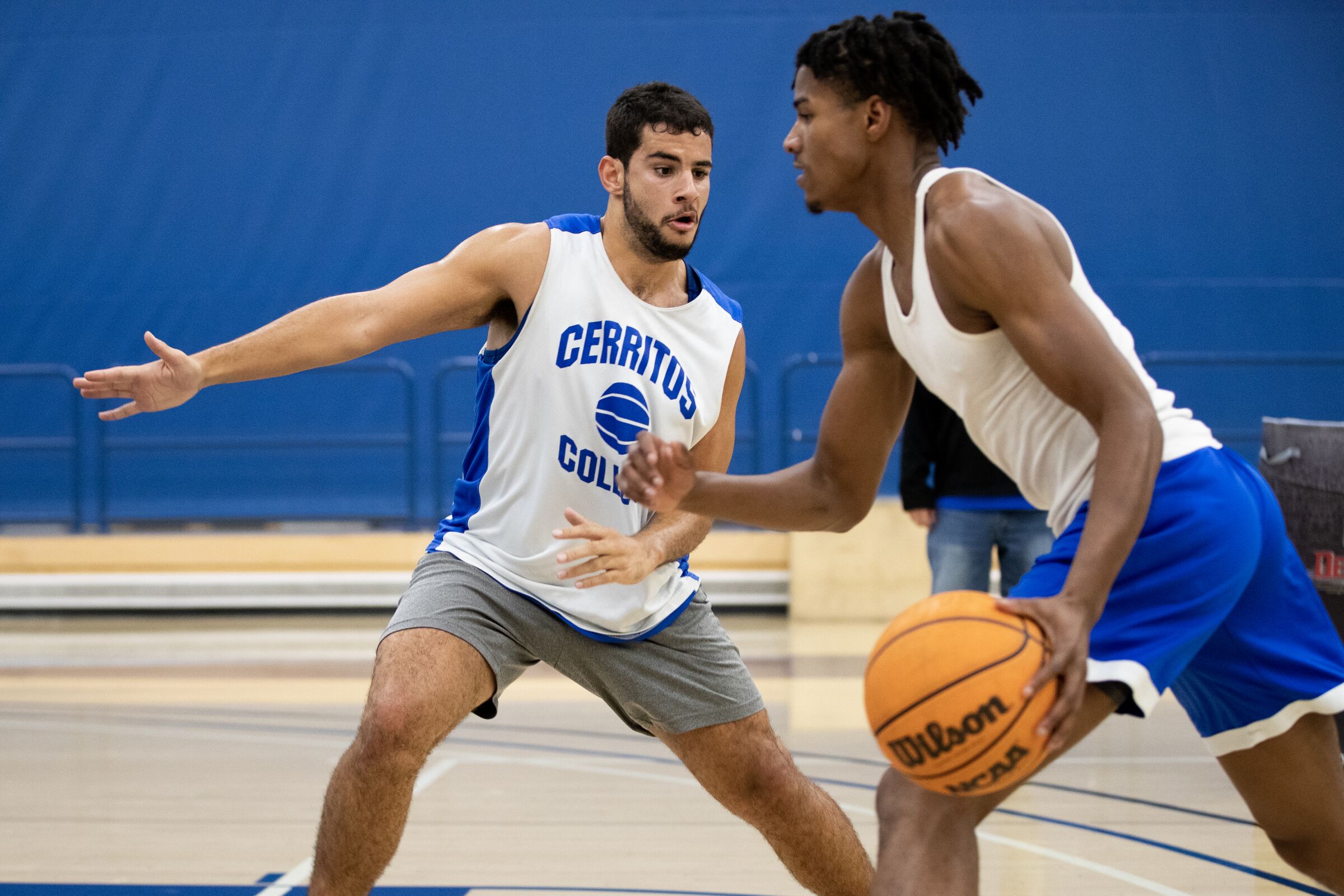 Kade West, left, a deaf and autistic student-athlete at Cerritos College, practices with teammate Malik Johnson.