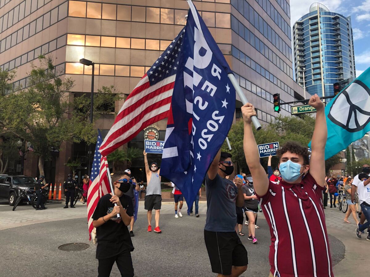 People celebrate in Orlando, Saturday after Democrat Joe Biden defeated President Donald Trump.