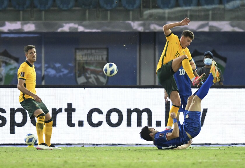Kuwait's Shabaib Alkhaldi, right, fights for the ball with Australia's Ajdin Hrustic during the World Cup 2022 Group B qualifying soccer match between Kuwait and Australia in Kuwait City, Kuwait, Thursday, June 3, 2021. (AP Photo/Jaber Abdulkhaleg)