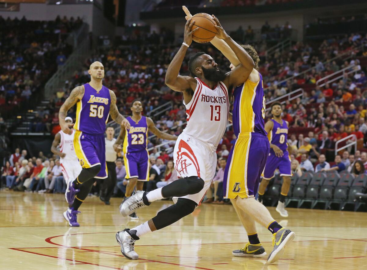 Rockets guard James Harden drives to the basket against Lakers guard Marcelo Huertas during a game Dec. 12 at Toyota Center in Houston.