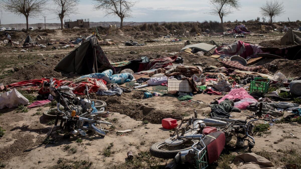 Destroyed vehicles left in an Islamic State camp on March 23, 2019, in Baghouz, Syria.