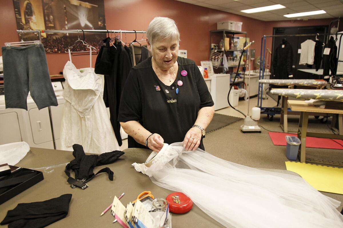 Costume director Barbara Poppa lays out a bridal veil as she prepares for a ballet performance at Segerstrom Center for the Arts. Poppa has been the costume director at Segerstrom Center since 1986.