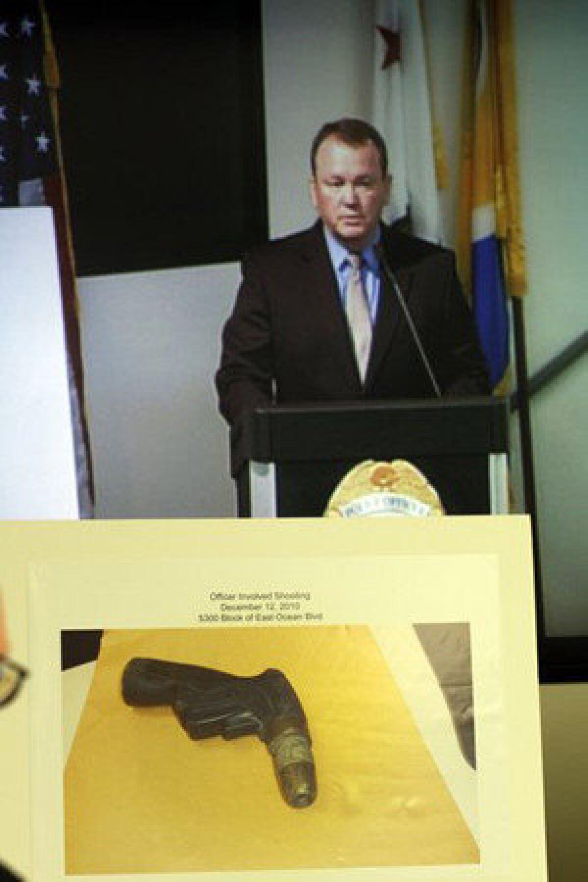 At a March 2011 news conference, Long Beach Police Chief Jim McDonnell displays a photo of the garden hose nozzle Douglas Zerby was holding when he was shot to death by police.