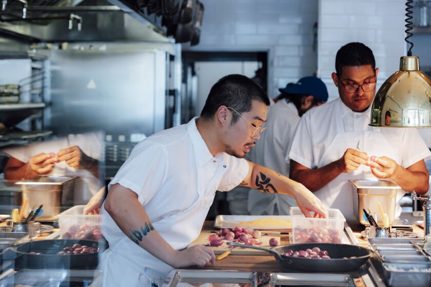 Los Angeles, CA - June 30: Chefs Max Boonthanakit (left) and Lijo George (right) prepare to open at Camphor on Thursday, June 30, 2022 in the Arts District of Los Angeles, CA. (Wesley Lapointe / Los Angeles Times)