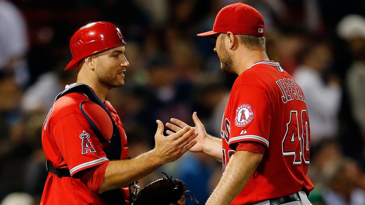 Angels catcher Chris Iannetta, left, and reliever Kevin Jepsen celebrate the team's 4-2 win over the Boston Red Sox on Monday.