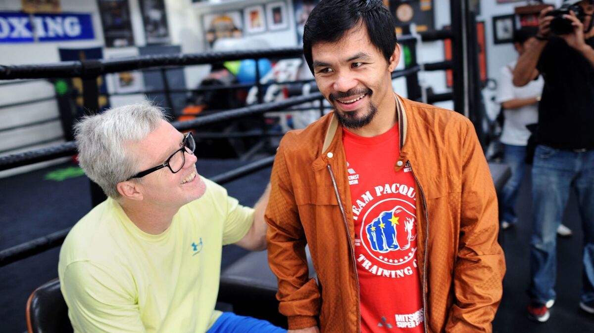 Freddie Roach, left, and Manny Pacquiao share a laugh after a workout at the Wild Card Boxing Gym in Los Angeles on March 31, 2016.
