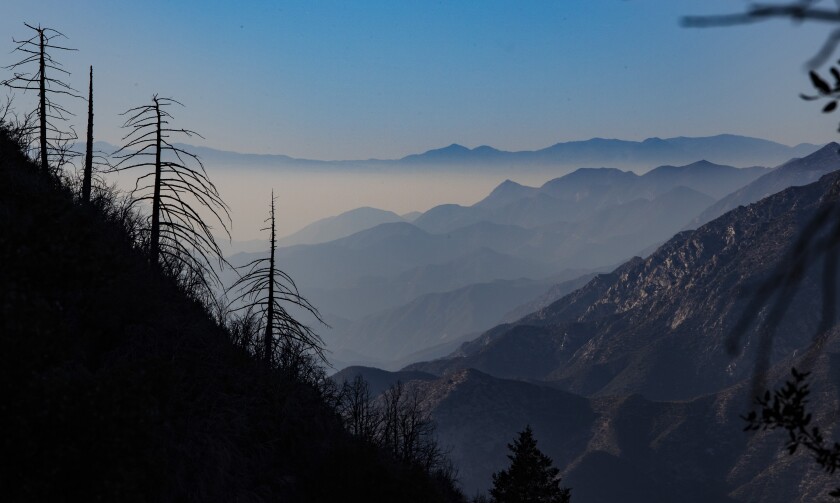 Low clouds drift into the mountains and valleys in a view along the road to Mt. Disappointment in the San Gabriel Mountains.