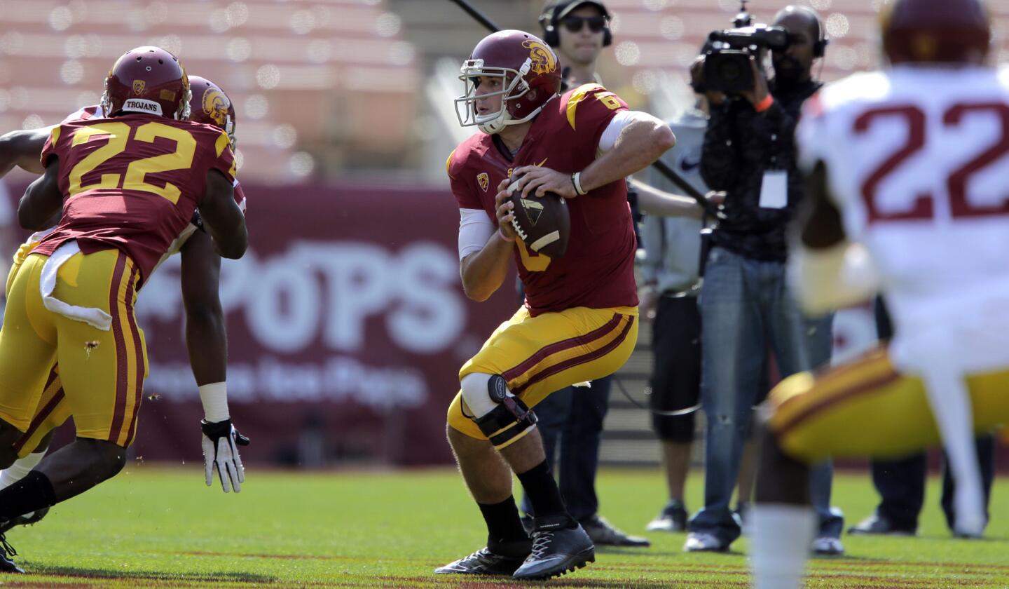 Quarterback Cody Kessler (6) scampers in the pocket during the annual spring game at the Coliseum on Saturday.