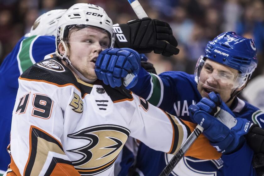 Anaheim Ducks' Max Jones, left, and Vancouver Canucks' Luke Schenn get into a scuffle during the third period of an NHL hockey game in Vancouver, British Columbia, Monday Feb. 25, 2019. Vancouver won, 4-0. (Darryl Dyck/The Canadian Press via AP)