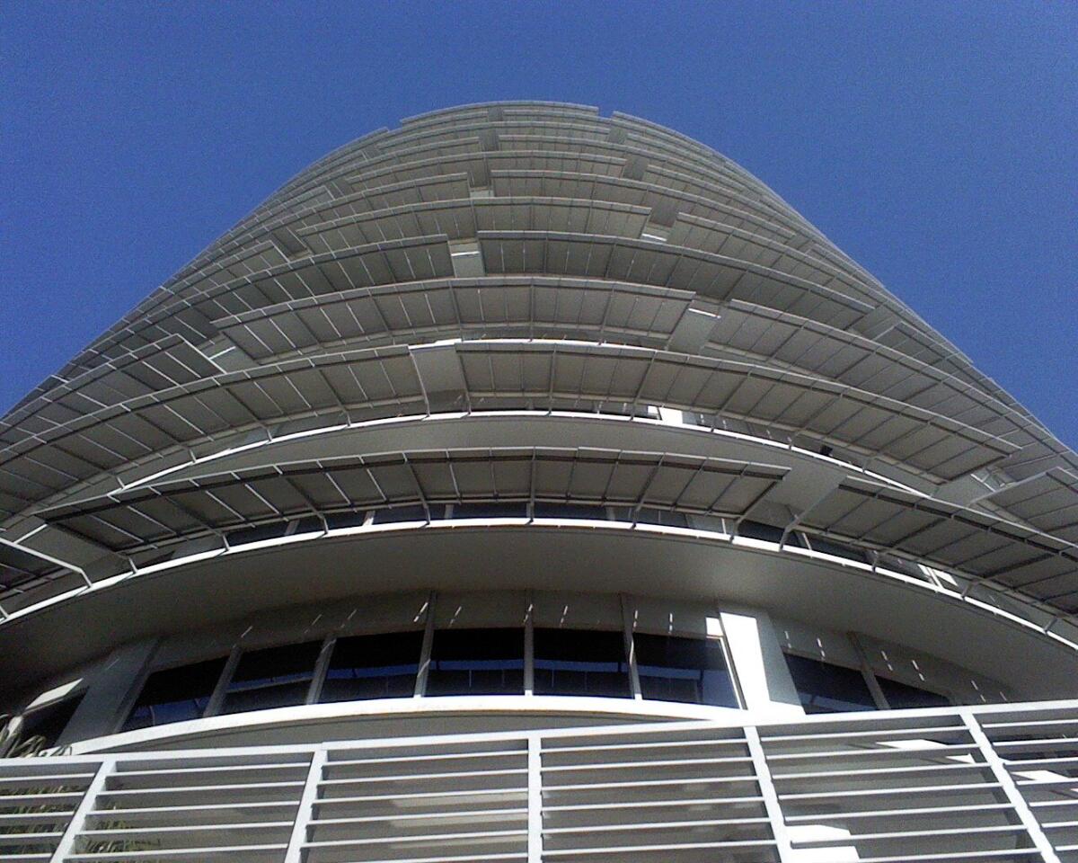 The Capitol Records building rising under a clear blue sky.
