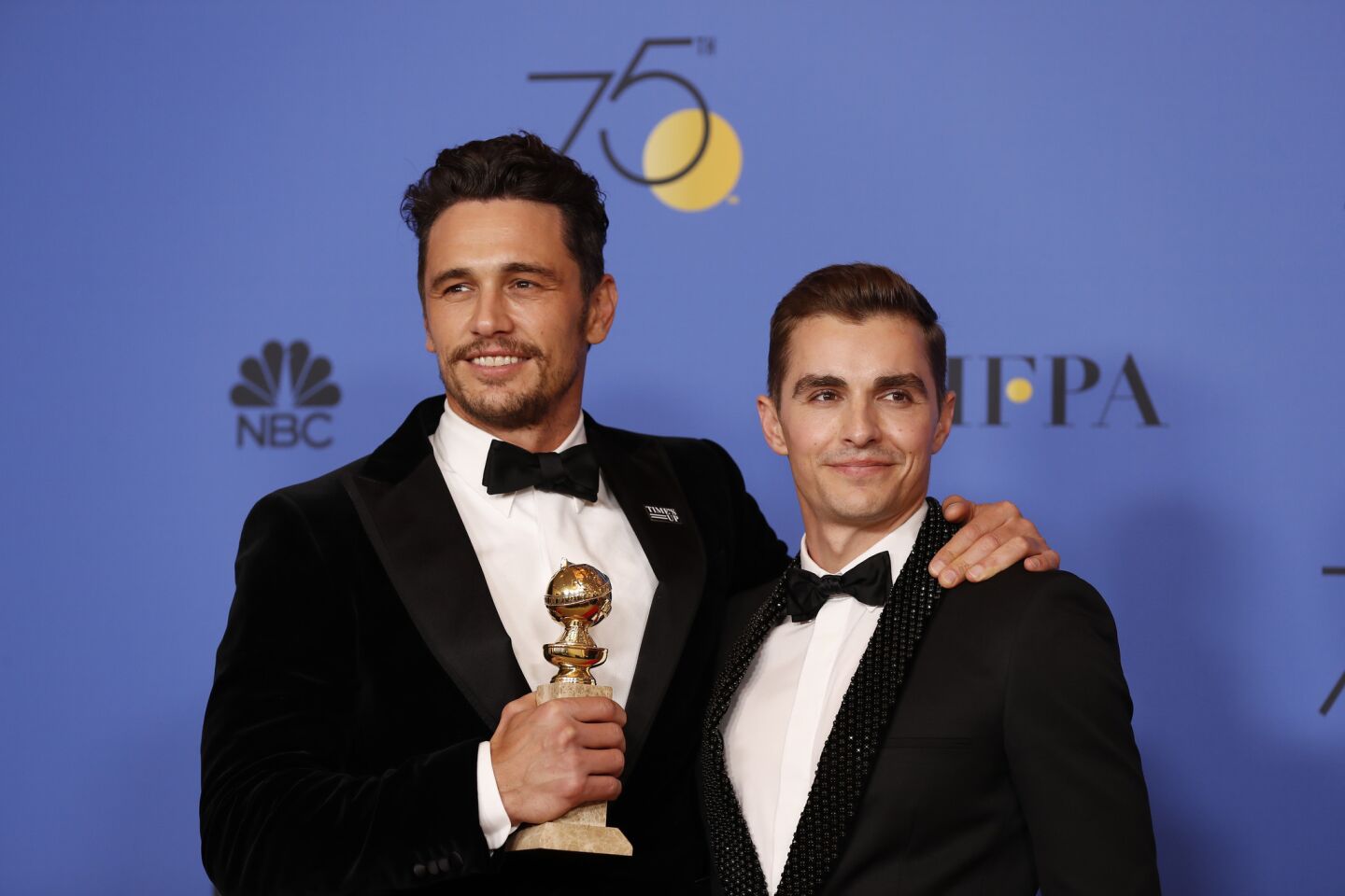 James Franco, left, who won the lead actor in a motion picture musical or comedy prize for "The Disaster Artist," with his brother Dave Franco.