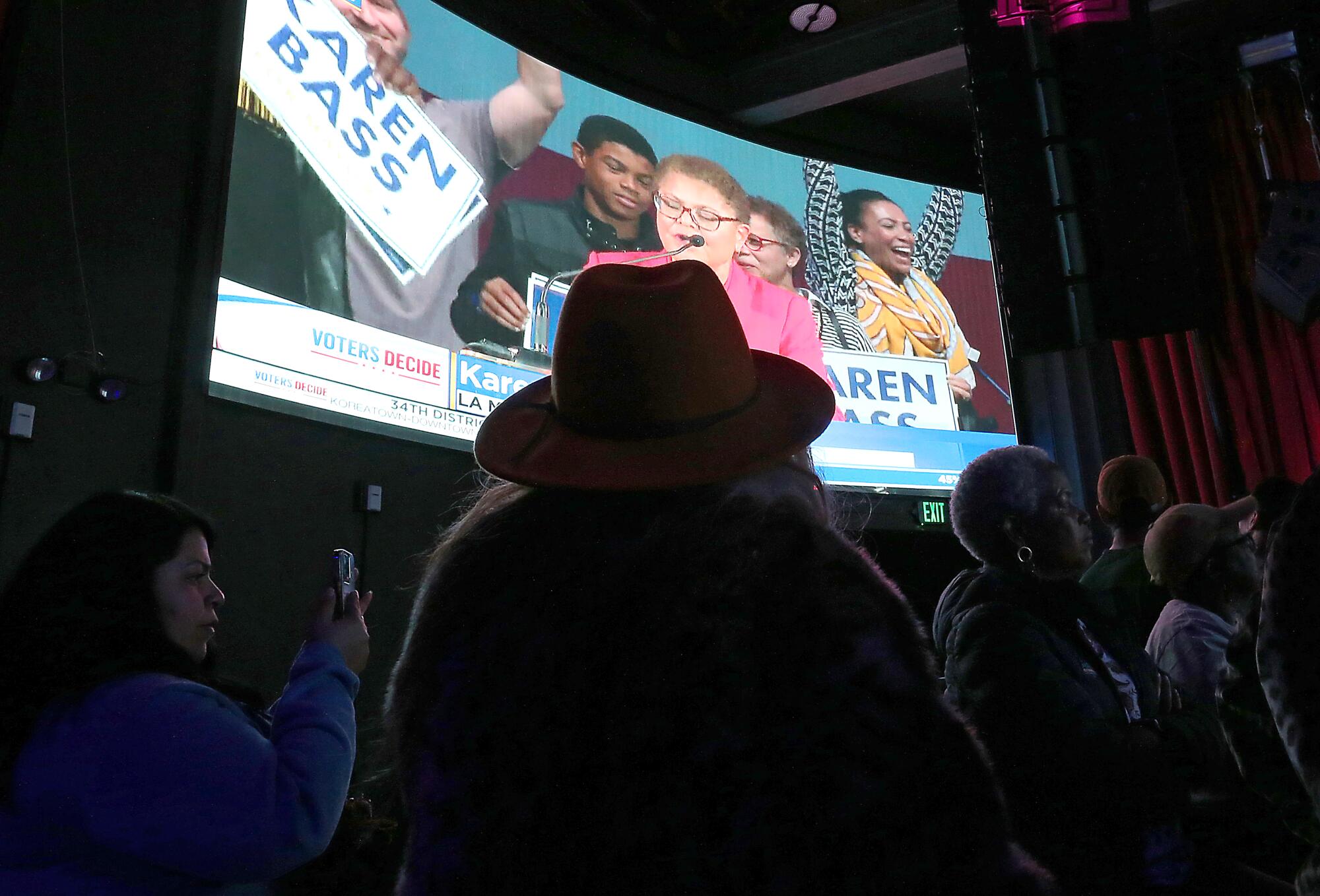 Supporters of City Councilman Mitch O'Farrell watch news coverage on a big screen