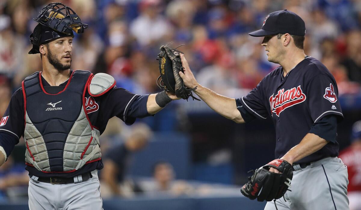 Cleveland Indians' Yan Gomes, left, congratulates teammate Jeff Manship after getting the final out of the eighth inning against the Toronto Blue Jays on July 1.