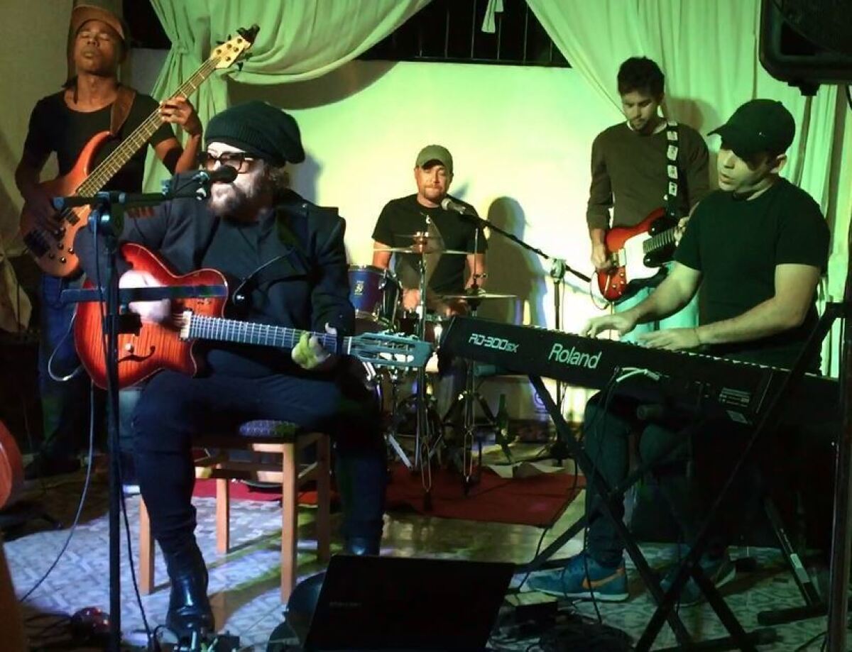 Roberto Gomez, second from right, in his role as lead guitarist for singer-songwriter Carlos Varela's band