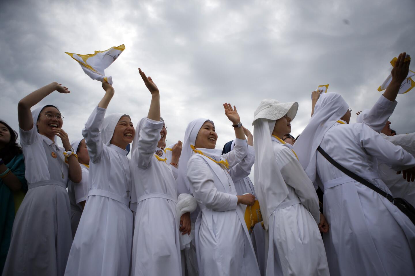 Nuns greet Pope Francis as he arrives to celebrate Mass in Haemi, South Korea, on Aug. 17.
