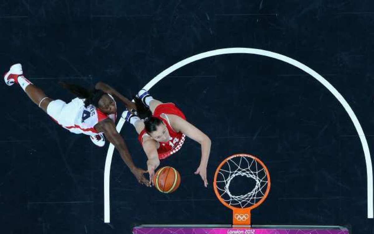 Luca Ivankovic, right, of Croatia and Tina Charles of the U.S. vie for a rebound.