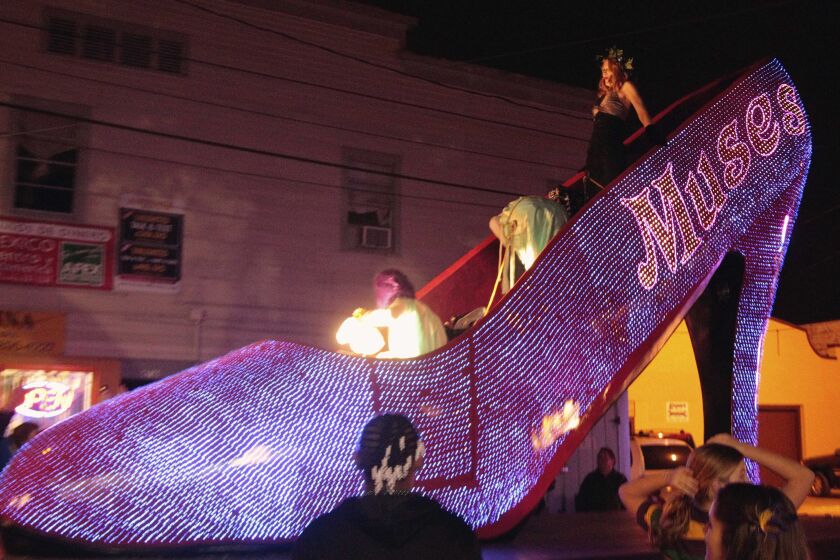 FILE - Actress Patricia Clarkson holds on as she rides in the Muses Mardi Gras Parade through the streets of New Orleans, Feb. 16, 2012. New Orleans city officials and business owners are celebrating plans to let the good times roll on longer routes with security bolstered by neighboring police agencies. Mayor LaToya Cantrell's official announcement Monday, Jan. 30, 2023, that parade routes were being lengthened was welcome news to Staci Rosenberg, a founder of the Krewe of Muses. (AP Photo/Bill Haber, File)
