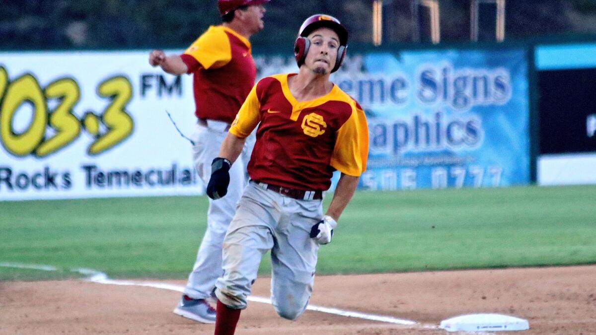 USC catcher Garrett Stubbs hustles home to score the game-winning run on a double by teammate Jeremy Martinez against San Diego State in the ninth inning of an NCAA regional elimination game Sunday afternoon.