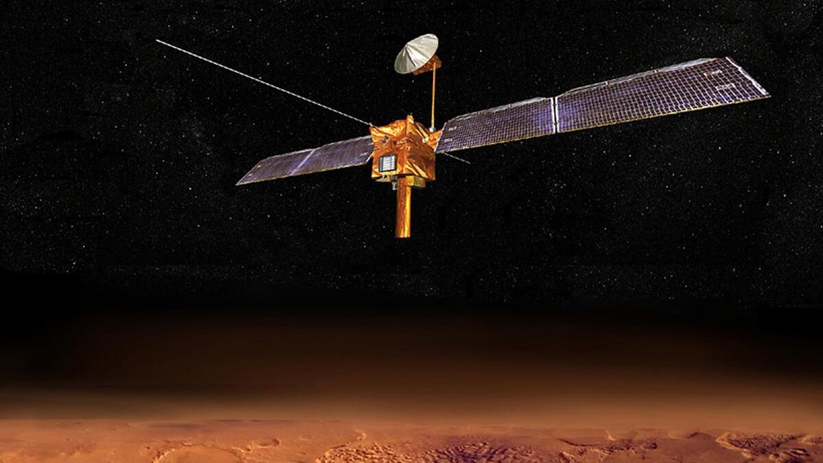 An artist's conception of the Mars Reconnaissance Orbiter taking measurements of the surface of the red planet from orbit. The spacecraft has detected deposits of water ice that could be useful to future explorers.