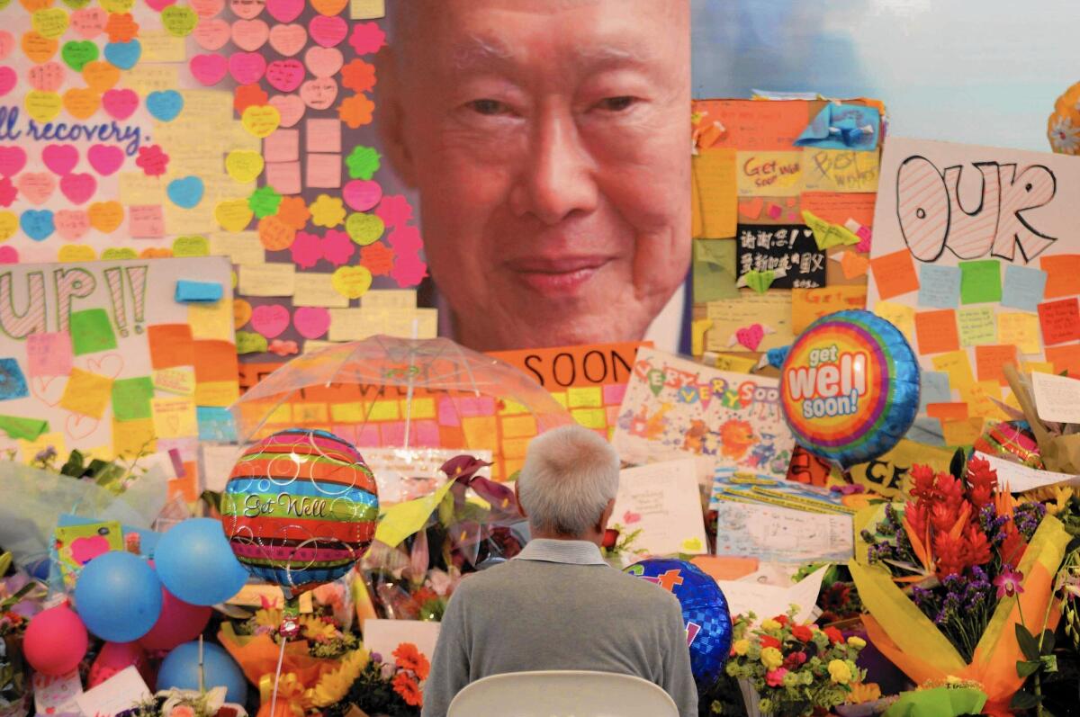 People pay their respects at Singapore General Hospital after the death of former prime minister Lee Kuan Yew.