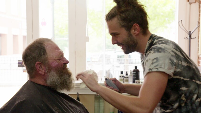 Jonathan Van Ness, right, goes to work on the beard of subject Tom Jackson on the Netflix revival of the makeover series "Queer Eye."