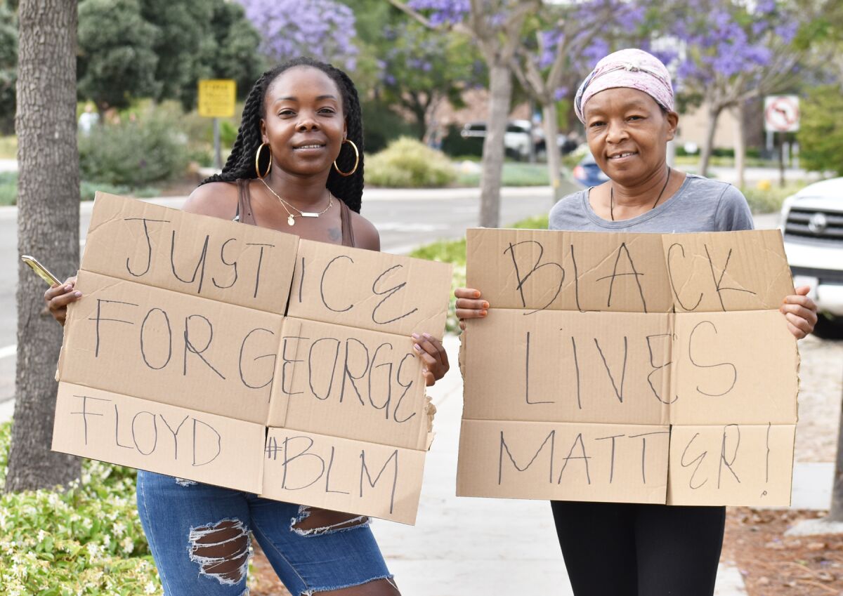 4S Ranch residents Linda Jackson and her mother, Mary Jackson holding protest signs that include black lives matter.