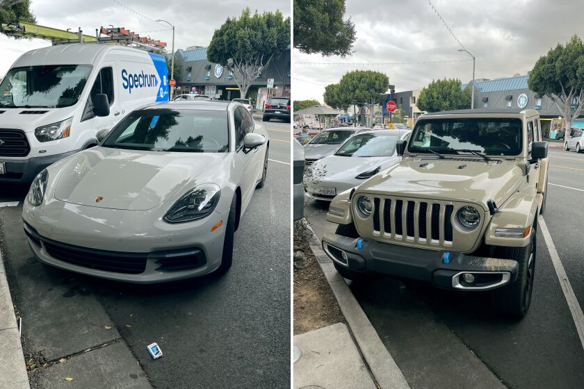 Two cars painted in muted earth tones - a Porsche Panamera, left, and a Jeep Wrangler, right - were parked a few spaces from each other on Larchmont Boulevard in Los Angeles on Feb. 13, 2023.