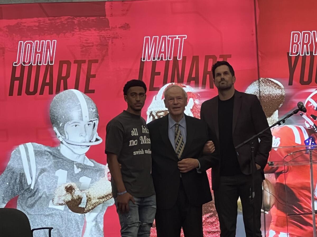 Bryce Young, from left, John Huarte and Matt Leinart pose for a photo at Mater Dei High.
