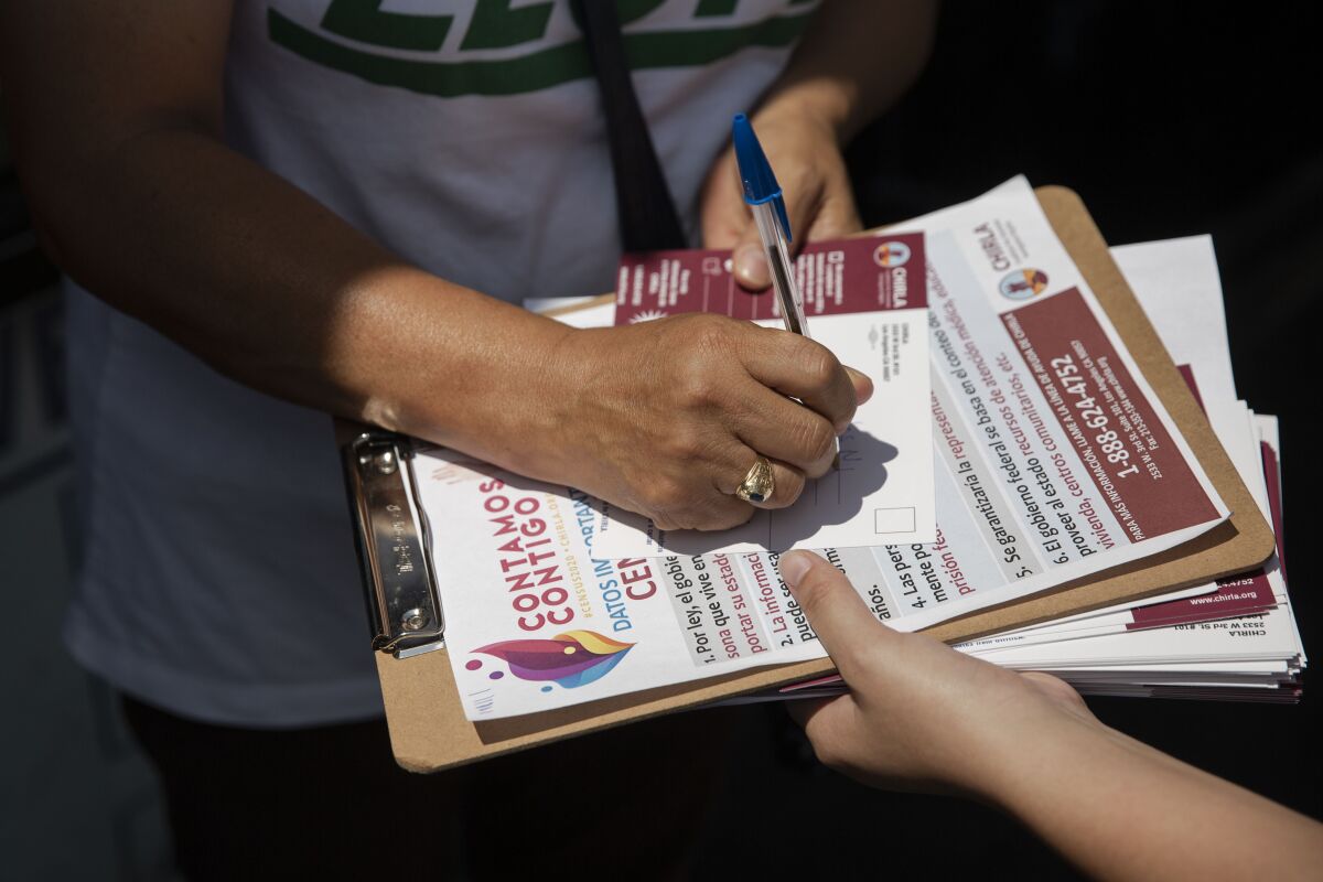 America Barrera, a youth volunteer with CHIRLA, helps Mercedes N. Martinez sign up for the census