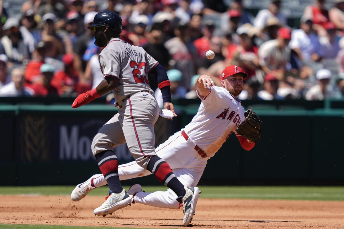 Angels third baseman Brandon Drury throws out Braves designated hitter Marcell Ozuna at first 