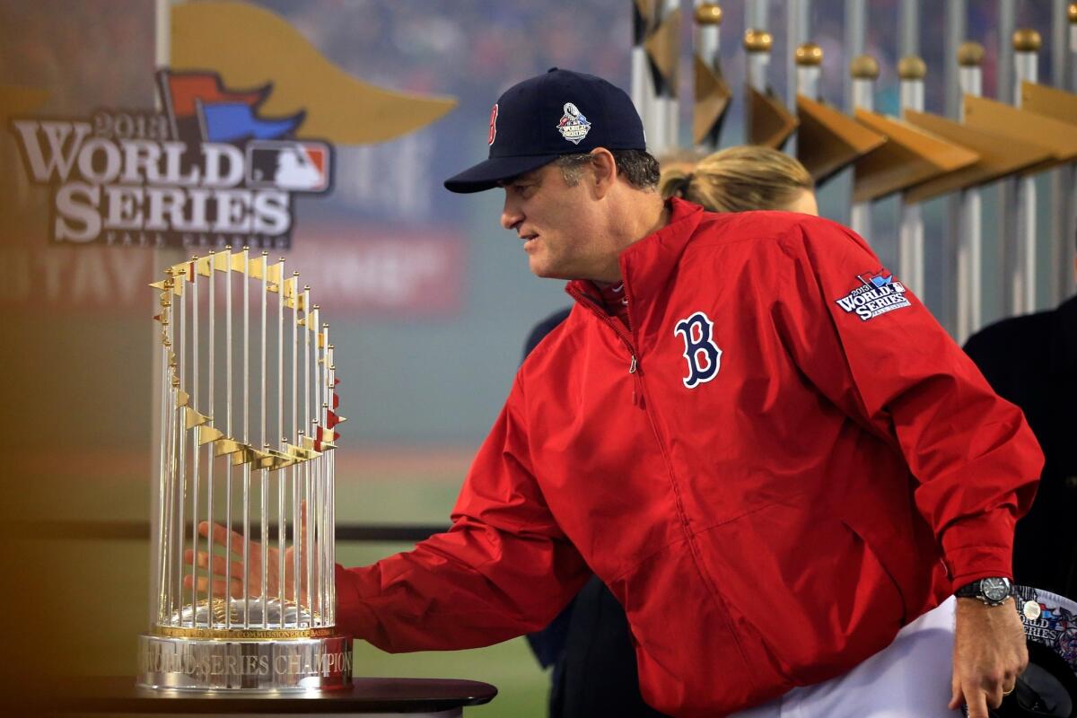 Boston Red Sox Manager John Farrell picks up the Commissoner's Trophy after his team's World Series win over the St. Louis Cardinals.